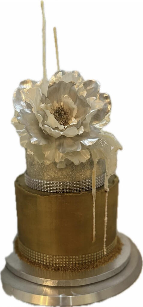 Chocolate ganache-covered cake hand-painted with edible gold and topped with a large ivory silk flower.